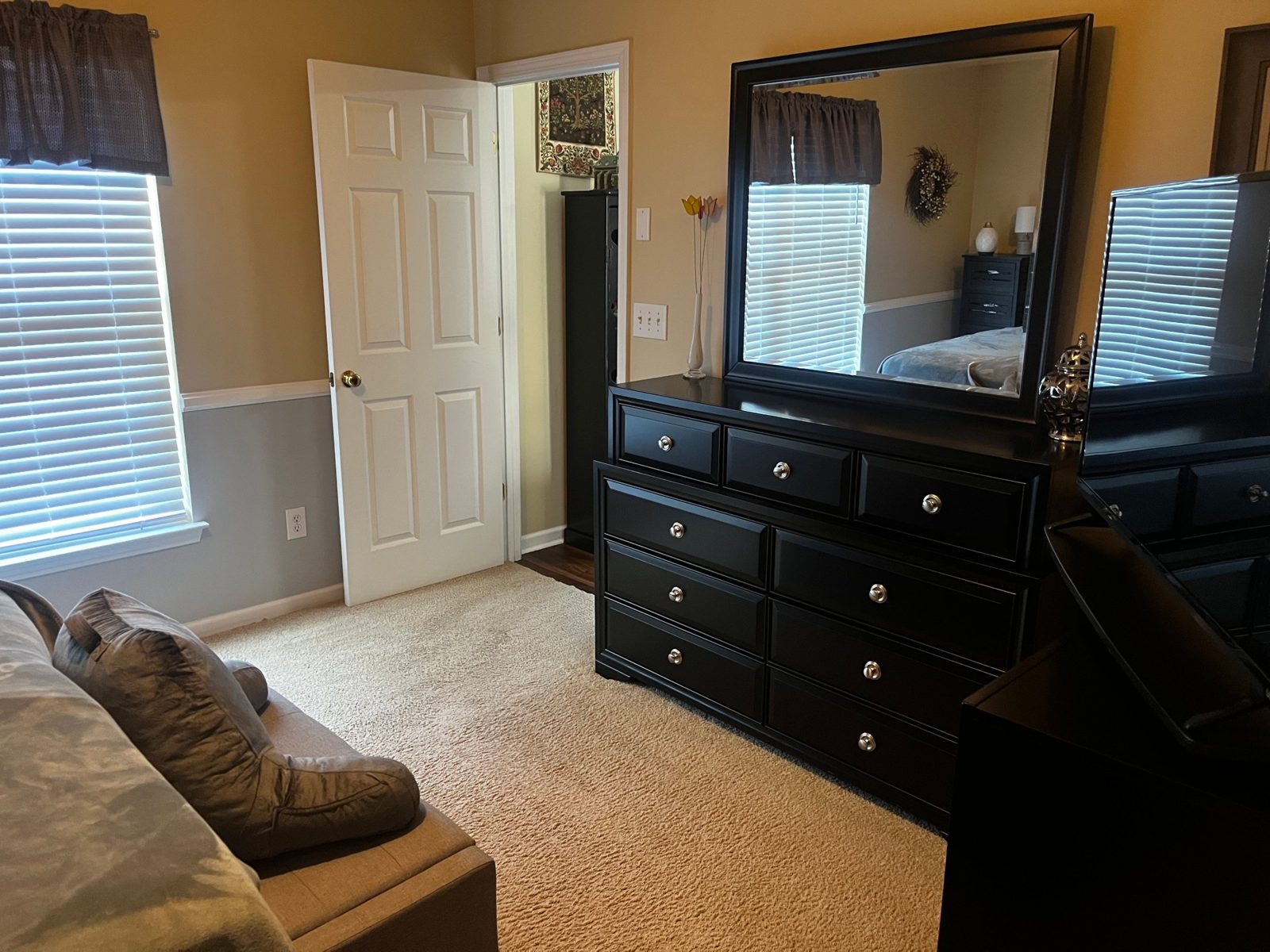 Bedroom with polished dresser and mirror