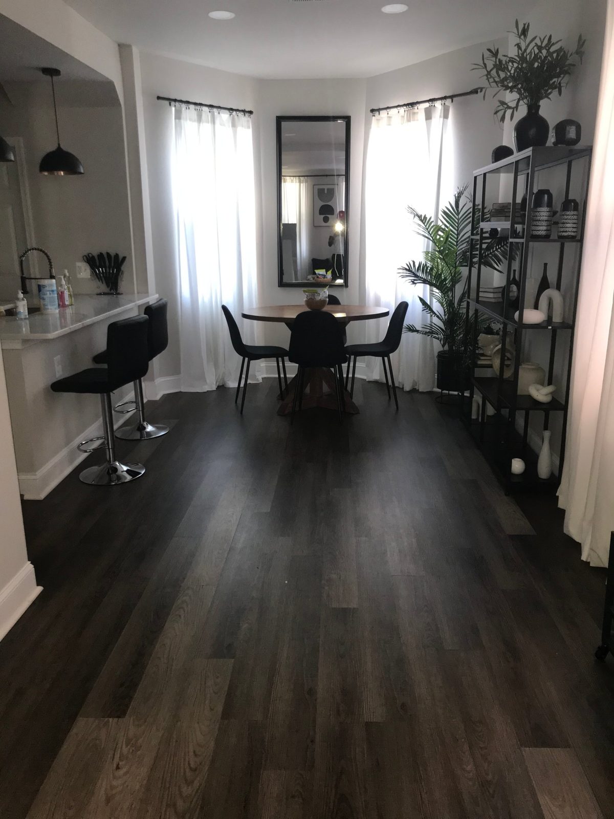 Dining area with dark wood floors and bright windows