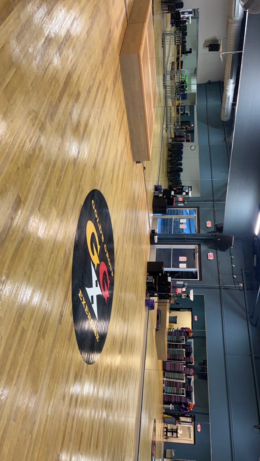 Group fitness studio with polished wood floor