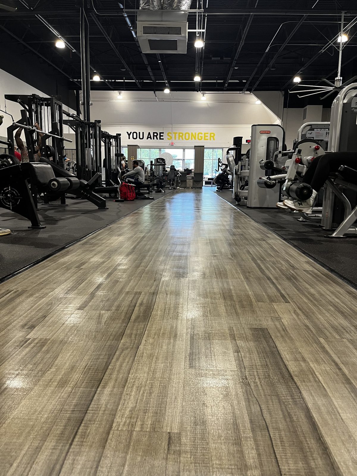 Gleaming wood walkway through a gym, cleaned by Lucky 7